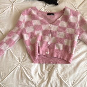 a pink/white checkered long-sleeve shirt